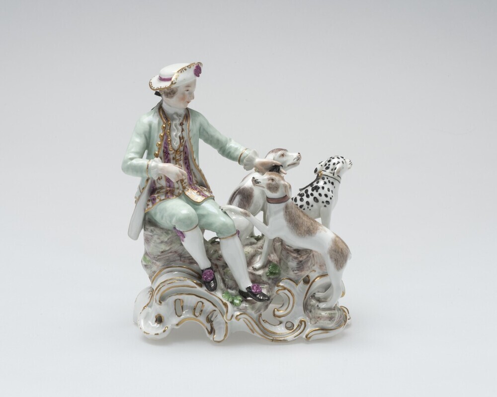 Zittende man bij jachthonden