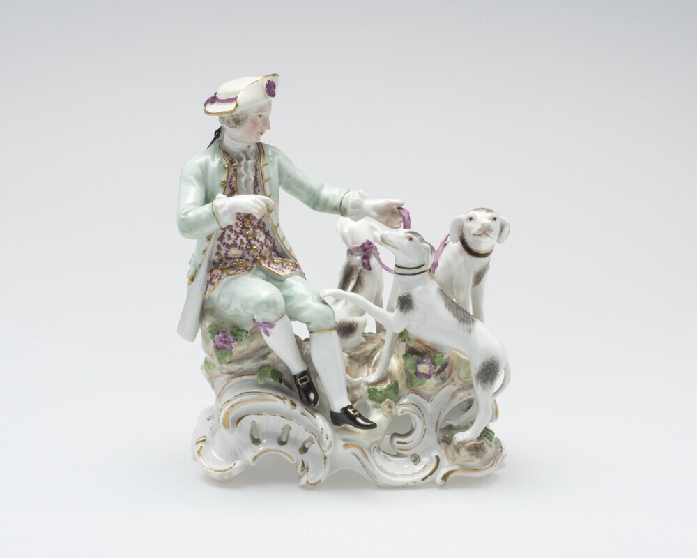 Zittende man bij jachthonden