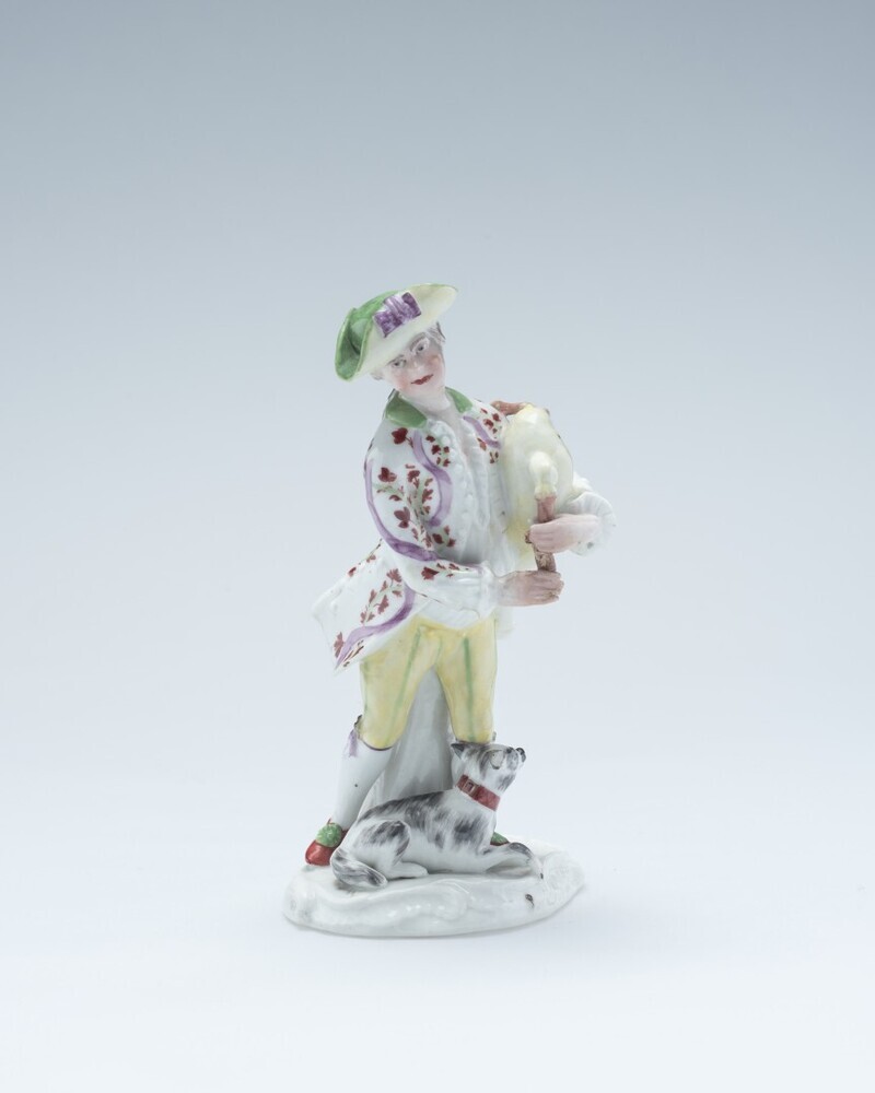 Jongeman met doedelzak en hond