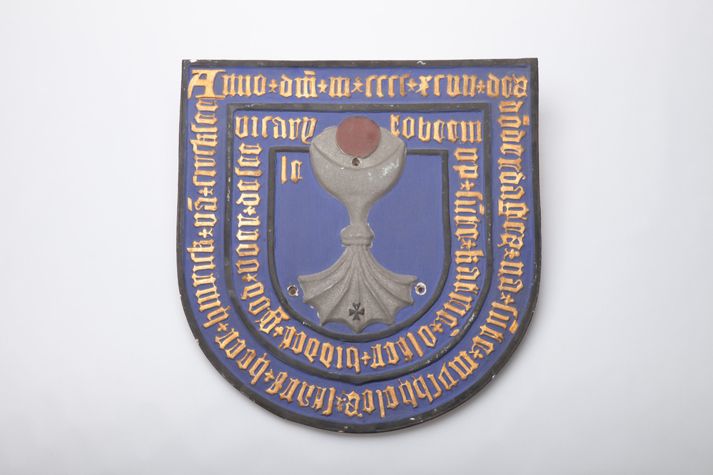 Gipsafgietsel van een bronzen schild van een graf.