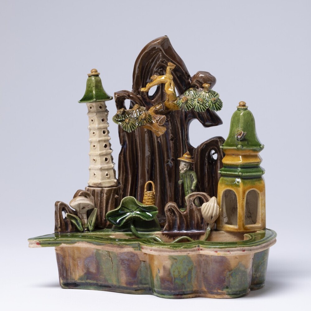 Beeldje van een vijvertje met pagoda, tentje, boom en visser