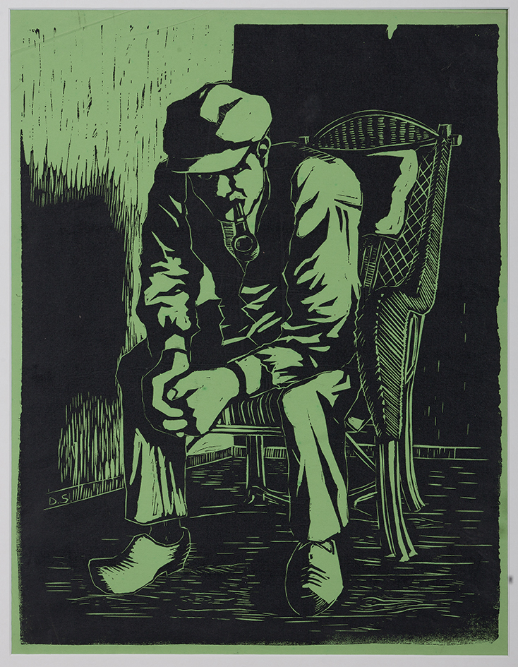 Pijprokende man in rieten stoel