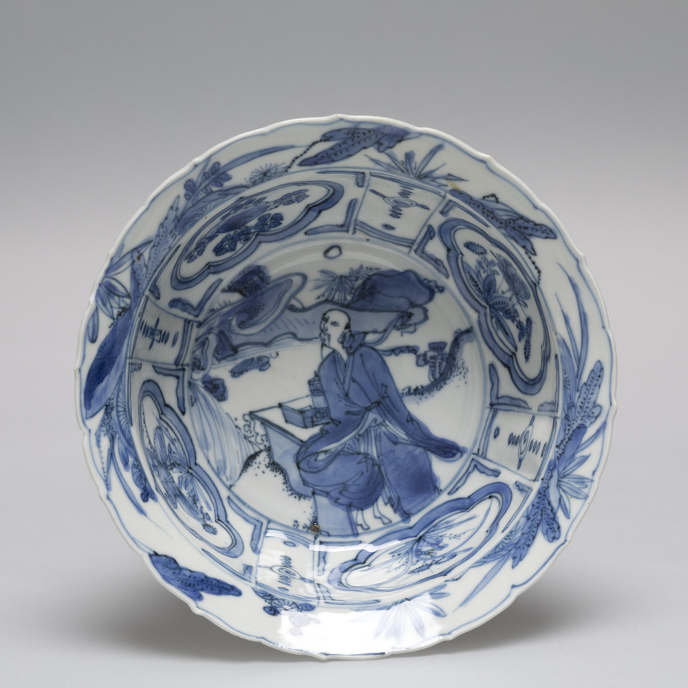 Klapmutskom met geleerde in een berglandschap