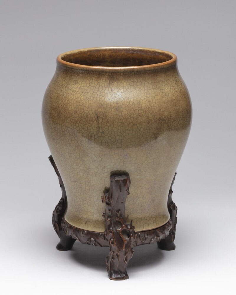 Balustervormige pot op bijpassend houten voet.