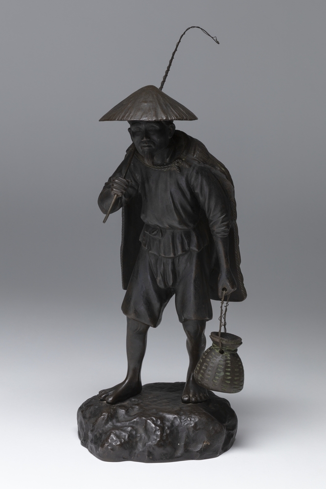 Visser met hengel en korf